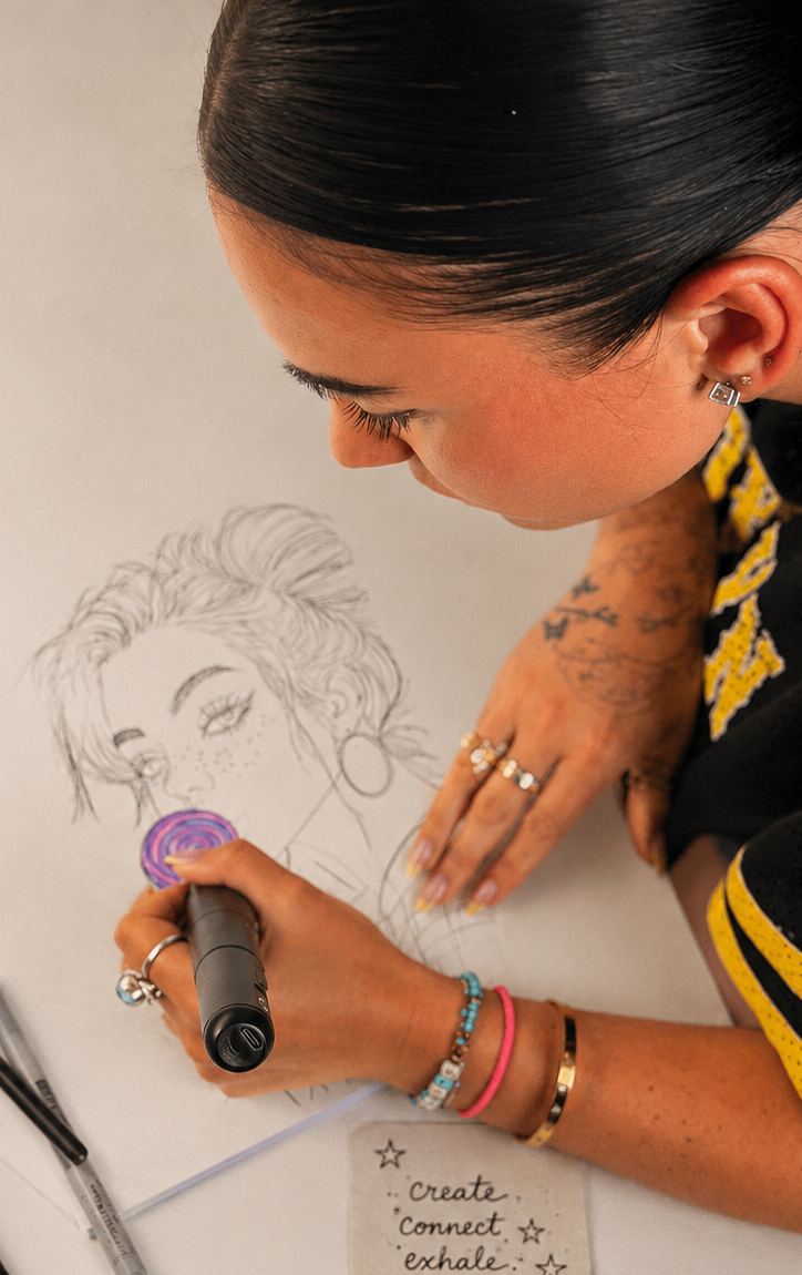 Taylor sketching at her studio table with the Astera