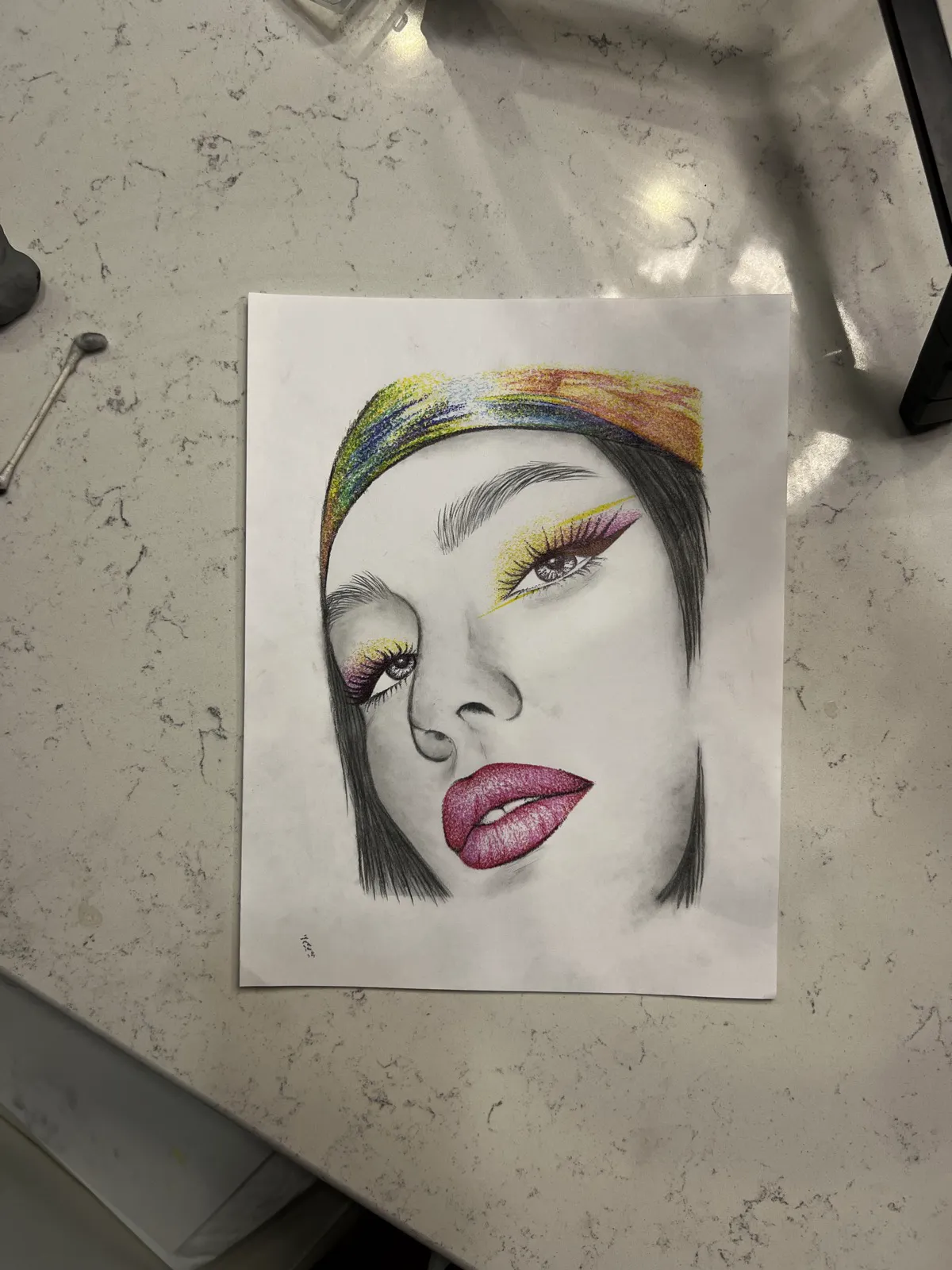 Colored pencil portrait with a rainbow headwrap, pink lips, and yellow liner