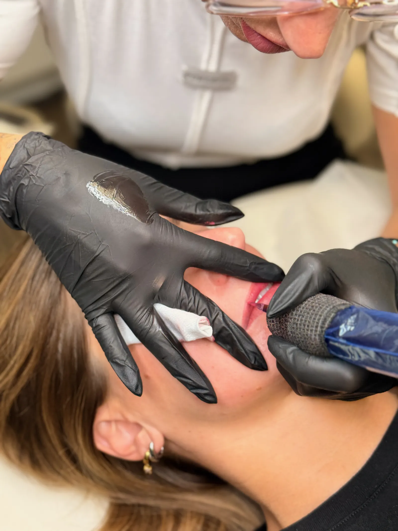 Lip work on a client in the studio