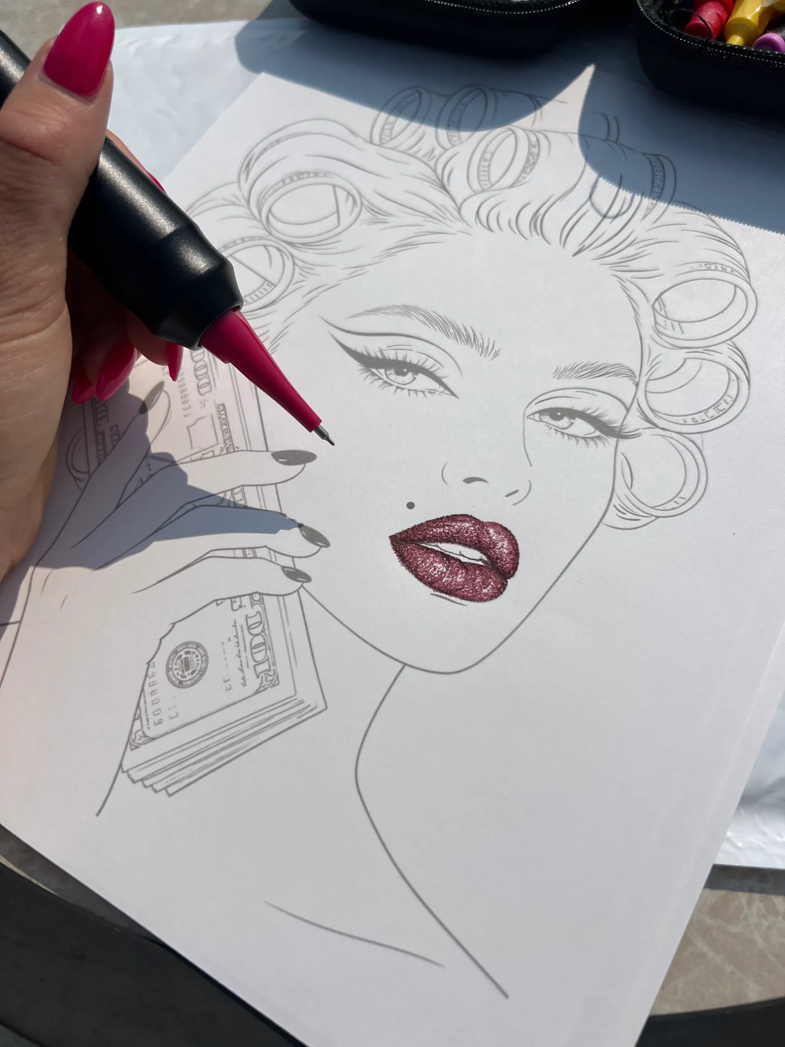 Stippled deep red lips on a pin-up face chart, pen in hand