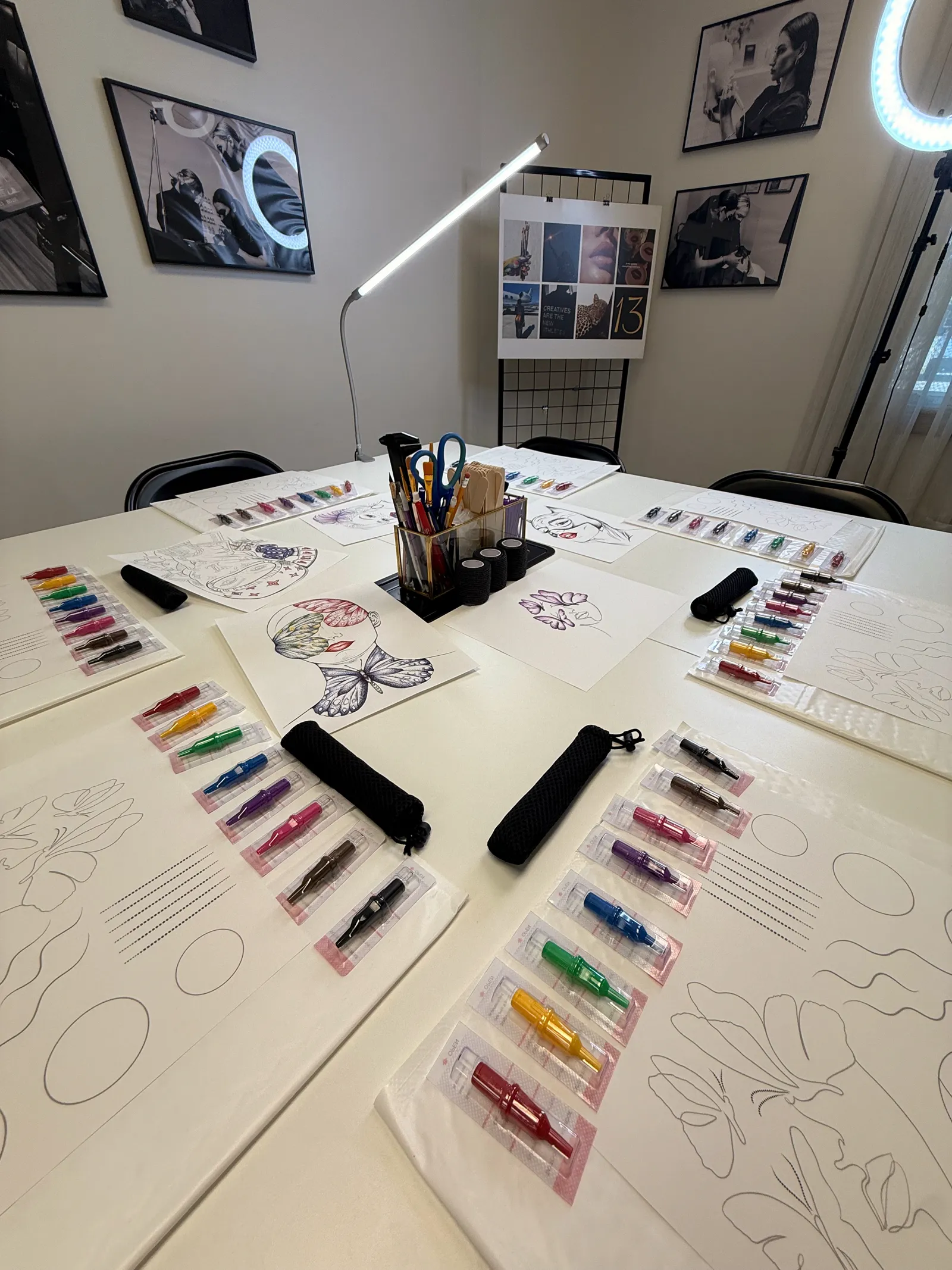 Classroom table set with practice sheets and rows of colored cartridges