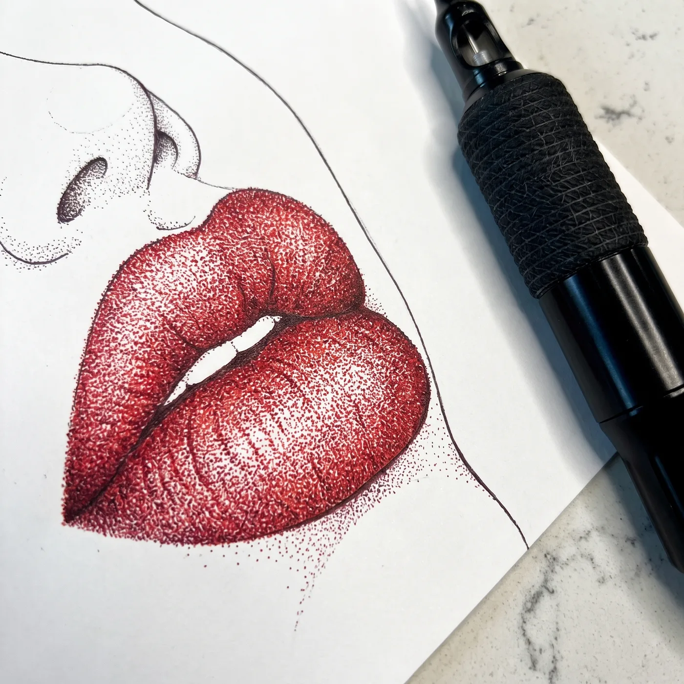 Macro of stippled red lips on a face chart beside the machine